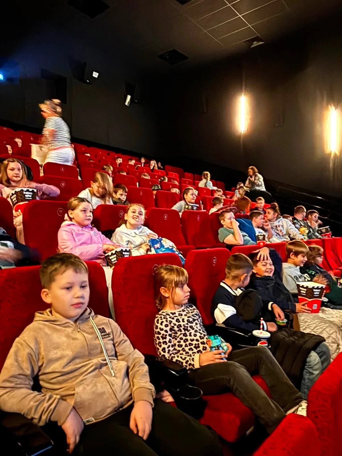 Year 1–3 pupils enjoying a shared visit to the cinema